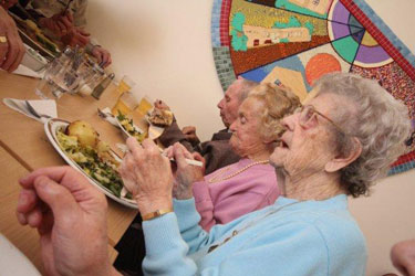Local residents enjoying a hot meal at the Lunch Club.